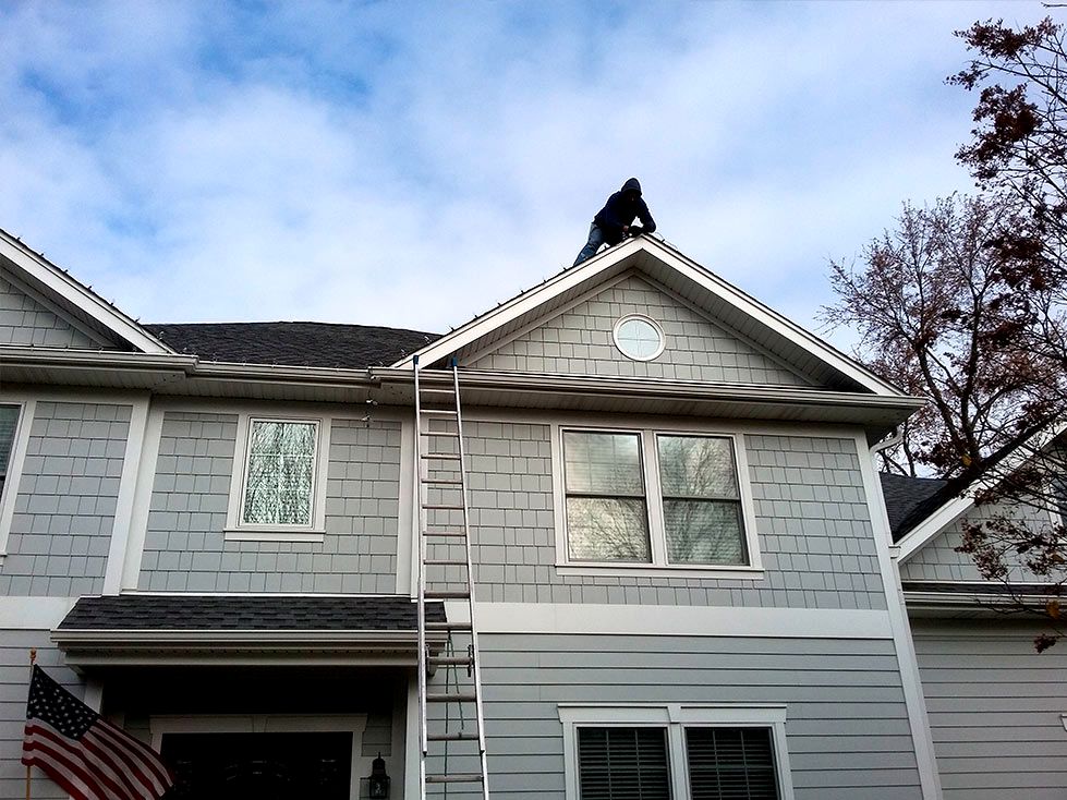 Gutter cleaned by hand, free of leaves and flowing freely
